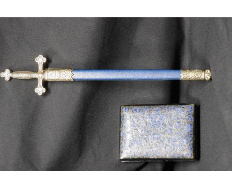 A Masonic letter opener in the form of a sword with scabbard and a papier mache painted lidded box.