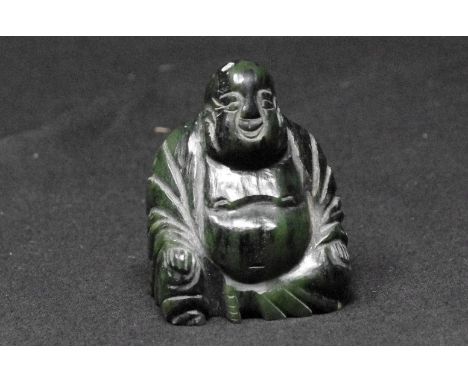 A carved jade Buddha, 8cm tall.