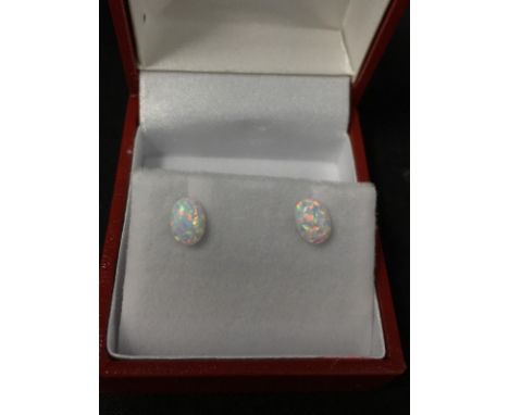 A pair of silver and opal stud earrings with case.