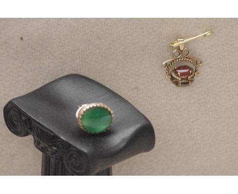 A jade and gold set fob and a gold revolving fob set with four semi-precious stones.