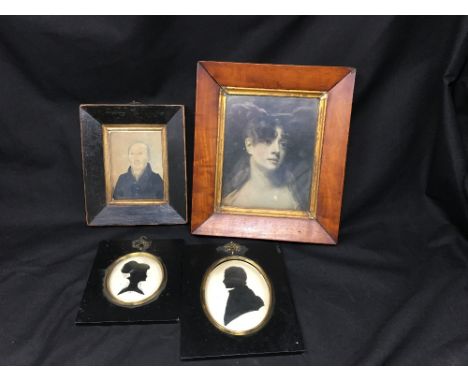An assortment of miniature framed and glazed portraits, including two silhouettes of a man and woman in side profile, plus a 