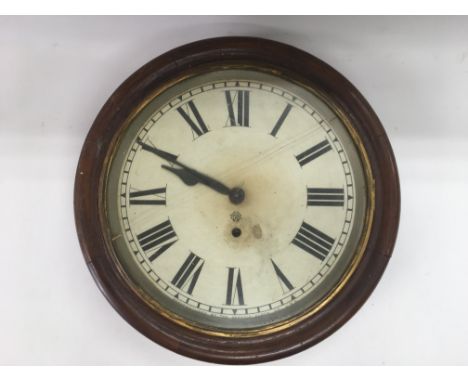 A mahogany wall clock manufactured by the Ansonia Clock Co USA, with large Roman numerals, crack to the glass.
