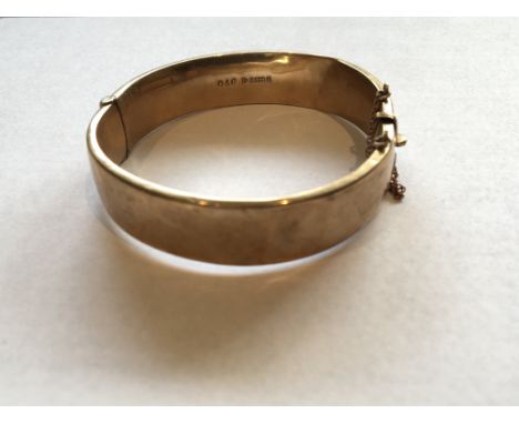 A 9carat Gold bangle with folate scroll decoration weight 15g approximately.