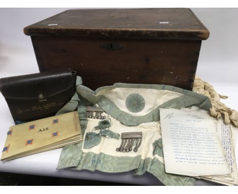 A vintage wooden chest containing various Masonic items.