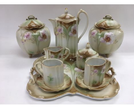 A ceramic cabaret set with hand painted on transfer floral decoration with a pair of conforming lidded vases.