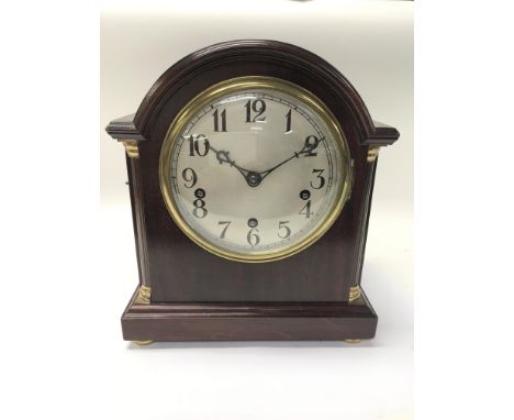 A mahogany mantel clock.