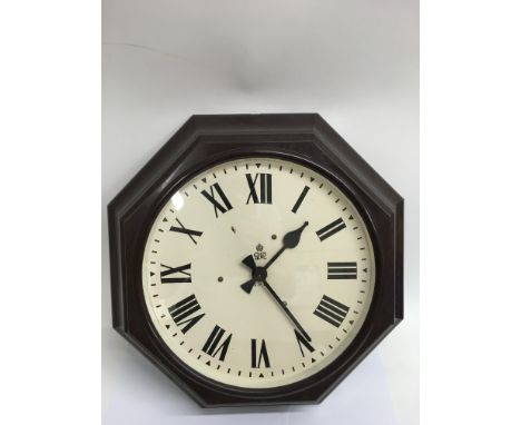 A large G.P.O Bakelite octagonal shaped clock with early electric movement and George V crown emblem to dial. Approx 43cm