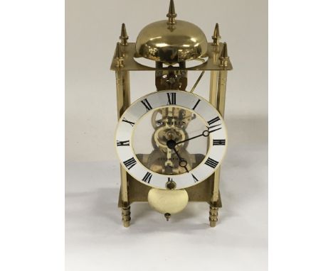 A modern brass single cylinder skeleton clock striking on a bell maker Swills Liverpool.