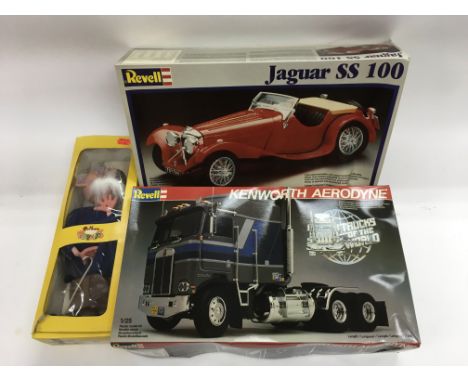 A collection of boxed Revell car and truck models and a boxed Pelham puppet.