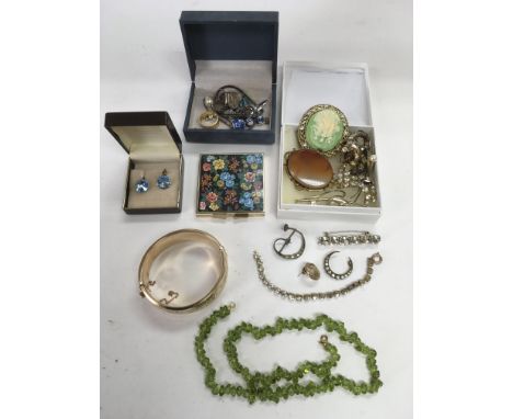 A small collection of costume jewellery including brooches, gold plated bangle etc.