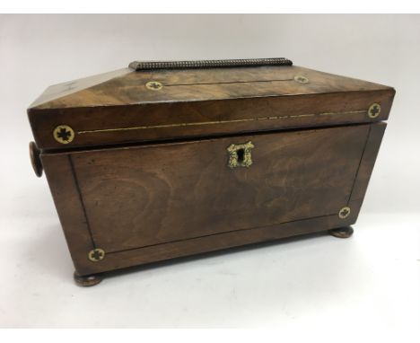 A mahogany tea caddy inlaid with brass motifs, approx 36cm x 16cm x 18cm.