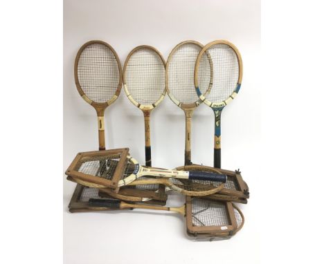 A quantity of vintage wooden sports rackets, mostly tennis, including a Slazenger Demon and a Spalding.