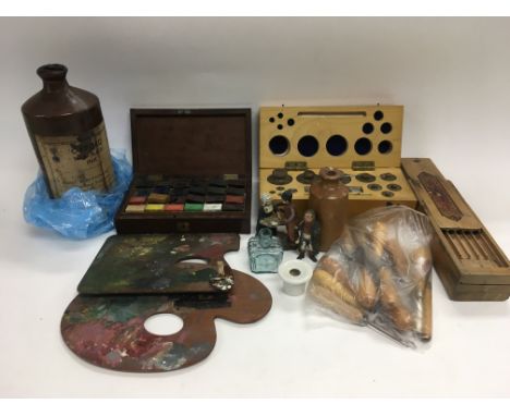 A box of oddments including artist's palettes, paints, rug making tools, a set of weights and other items.