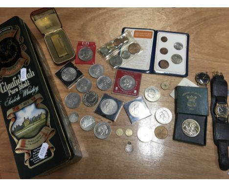 A collection of commemorative coins, a cased Dunhill lighter and 2 watches in a scotch whisky tin