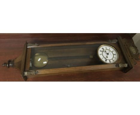 A Spanish wooden wall clock, the metal dial marked M.Rodriguez Amate, Sevilla.Approx 110cm long