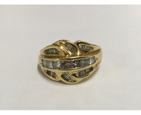 An 18k gold ring set with multi princess cut and baguette diamonds. Size approx K, weight approx 9.4g