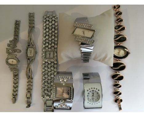 A collection of 7 very sparkly dress watches with some designer names including Morgan, DKNY amongst others. All in working o