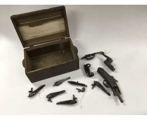 A box containing various vintage gun parts