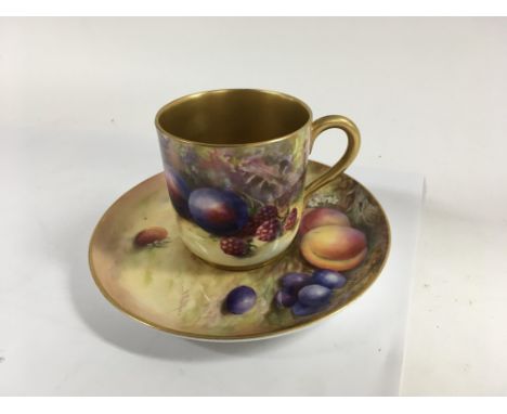 A Royal Worcester cup and saucer decorated with fruit and foliage signed