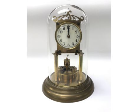 A brass anniversary clock under a glass dome.