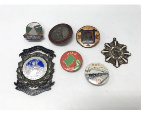 A collection of enamel badges including motoring examples.