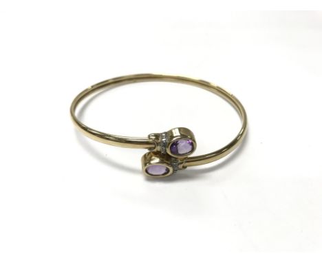 A 9ct gold amethyst bangle. Weight approx 7.1g