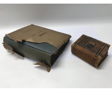 An early 20th century post card album together with a small photograph album.