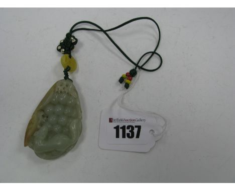 A Jade Pendant, of oval form carved with a Kylin and grapes, on a knotted and beaded cord, 7cm long.
