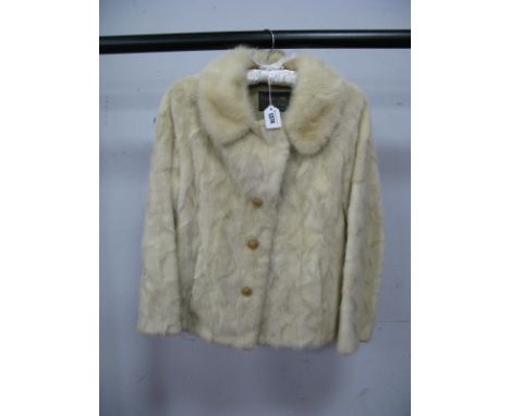 A Ladies White Female Mink Evening Jacket, the pelts with a 'diamond' effect, side splits and half back belt, decorative butt
