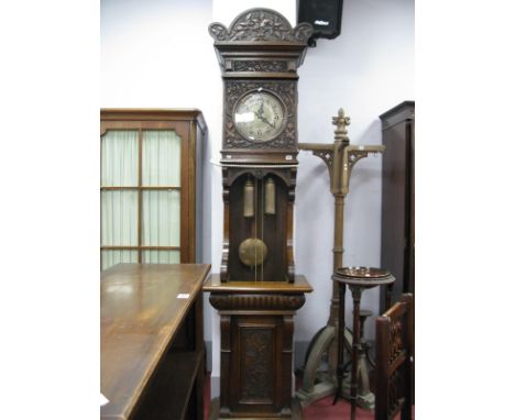 A Late XIX Century German Carved Oak Eight-Day Longcase Clock, with carved shaped pediment, the hood relief carved with scoll
