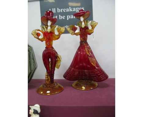 A Pair of Murano Mid XX Century Venetian Carnival Figures, in ruby and amber costumes, upon circular bases, 37cm high. (2)