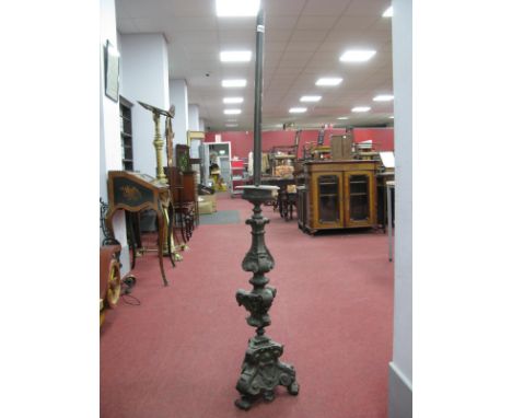 A Late XIX Century Metal Standard Lamp, elaborately cast with scrolling foliage and shell motifs upon a tripod base, 43cm hig