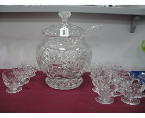 A Mid XX Century Heavy Cut Glass Punch Bowl, Cover and Ladle and Eleven Single Handled Cups, decorated with a starburst desig