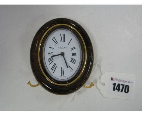A Cartier Easel Alarm Clock, with an outer marble effect frme, the white dial with Roman numerals, inscribed "Cartier, Paris 