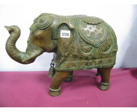 A Mid/Late XX Century Indian Brass Elephant, with trunk up and wearing a bell around it's neck, and elaborately decorated jho