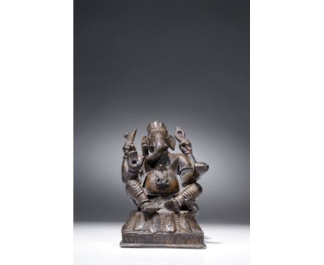 BronzeIndia, 14th to 15th centuryDimensions: Height 11,8 cm by 7,5 cmWeight: 991 gramsGanesha seated on a throne made of lotu