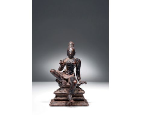 BronzeIndia, 16th to 17th centuryDimensions: Height 9 cm by 5,5 cmWeight: 249 gramsA goddess seated on a lotus flower on a sq