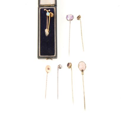 A yellow metal stick pin with pink stone (untested), the round mixed cut pink stone (untested) claw set in a plain oval surro