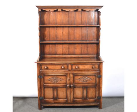 Reproduction golden oak dresser, with a three-shelf delft rack, over drawers and panelled doors, width 122cm, depth 44cm, hei