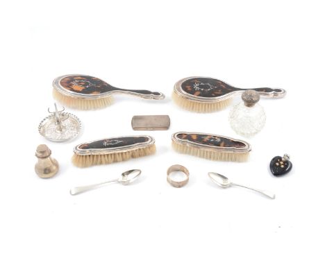 A four piece silver and tortoiseshell-backed dressing table brush set, marks rubbed; a silver ring tree, Jay, Richard Attenbo