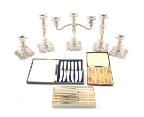 A set of five candle holders, comprising candelabra, pair of candlesticks and pair of dwarf candlesticks; plated cutlery; and