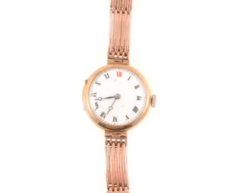 A lady's 9ct rose gold wrist watch, white enamel 22mm dial with black and red arabic numerals, outer chapter ring of gold-col