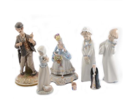 Seven ceramic figures including a Nao child holding a puppy, and a Capodimonte drunkard holding a bottle of whisky.