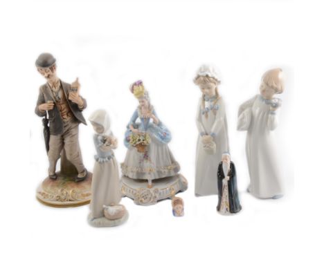 Seven ceramic figures including a Nao child holding a puppy, and a Capodimonte drunkard holding a bottle of whisky.