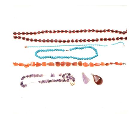 A turquoise bead necklace, lobster claw clasp marked 925, 42cm; two ruby-coloured glass bead necklaces, 44cm and 46cm; a stri