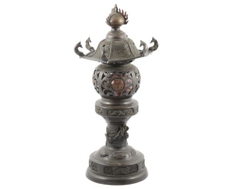 Chinese style table lamp, bronzed effect, pierced shade below a canopy, vase shape base, height 47cm.