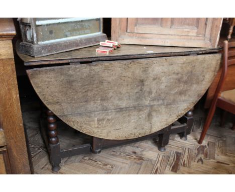 An early 18th Century oak gate leg table on bobbin turned supports, approx. 150cm x 127cm when open