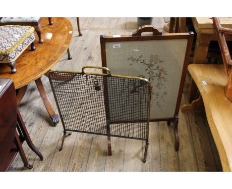 An oak embroidered fire screen together with a brass wire fire screen