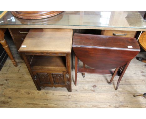 A carved oak one door cupboard together with a mahogany gate leg table