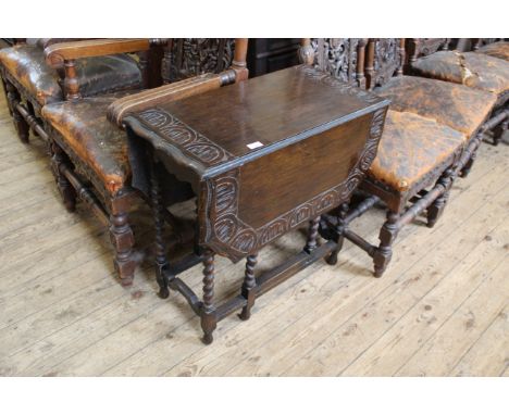 An early 20th Century carved oak gate leg table